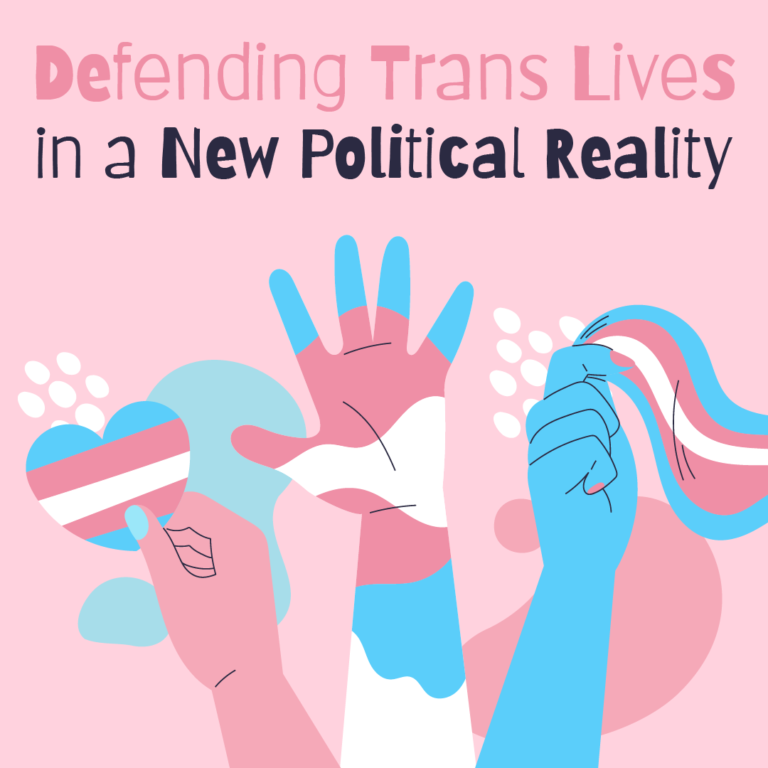 A digital illustration advocating for transgender rights features three stylized hands against a pale pink background: one holding a heart with transgender pride colors, another raised with fingers spread and decorated in the trans flag’s colors, and a third grasping a section of a transgender pride flag. The hands are drawn in a soft, cartoon style with smooth lines, and white abstract shapes accent the background. At the top, bold sans-serif text reads: “Defending Trans Lives in a New Political Reality.”